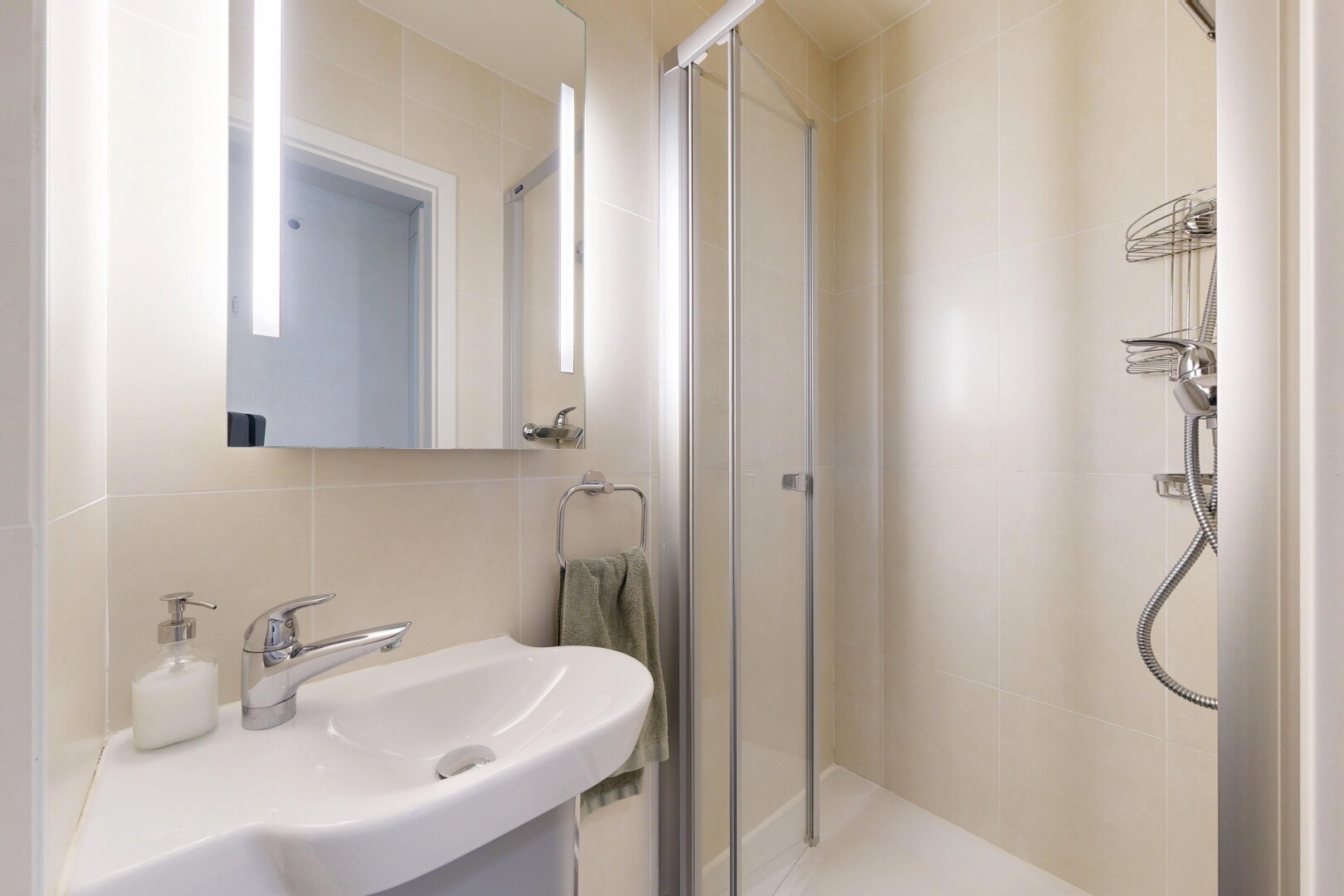 full bathroom with a stall shower, tile walls, vanity, and tasteful backsplash