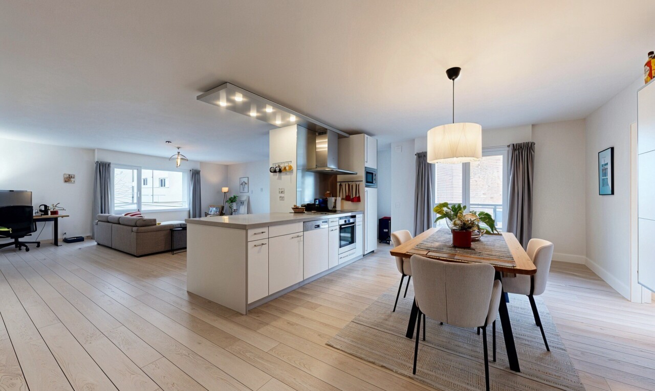kitchen featuring white cabinets, light countertops, light wood-type flooring, and open floor plan