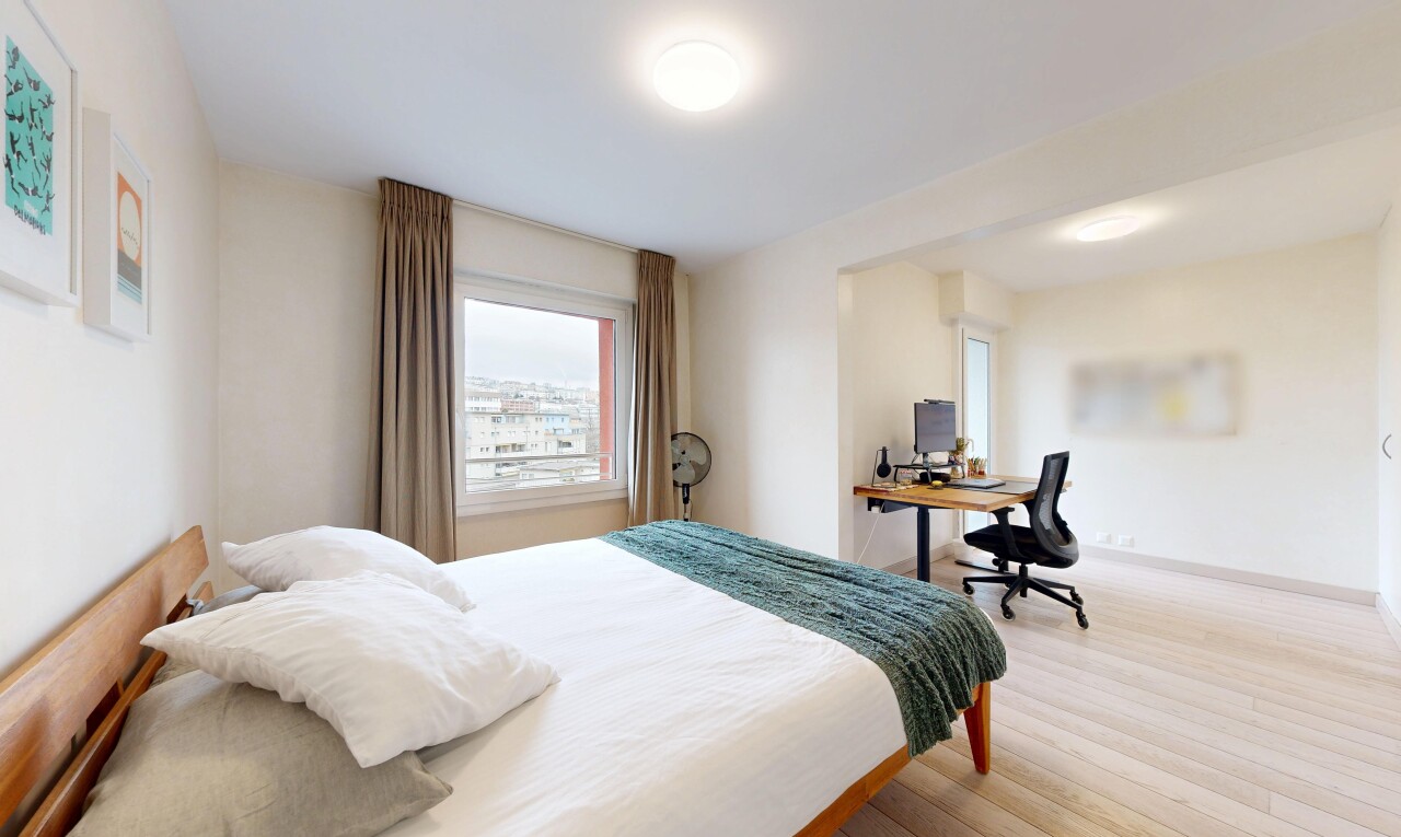room / bedroom with a desk and wood finished floors