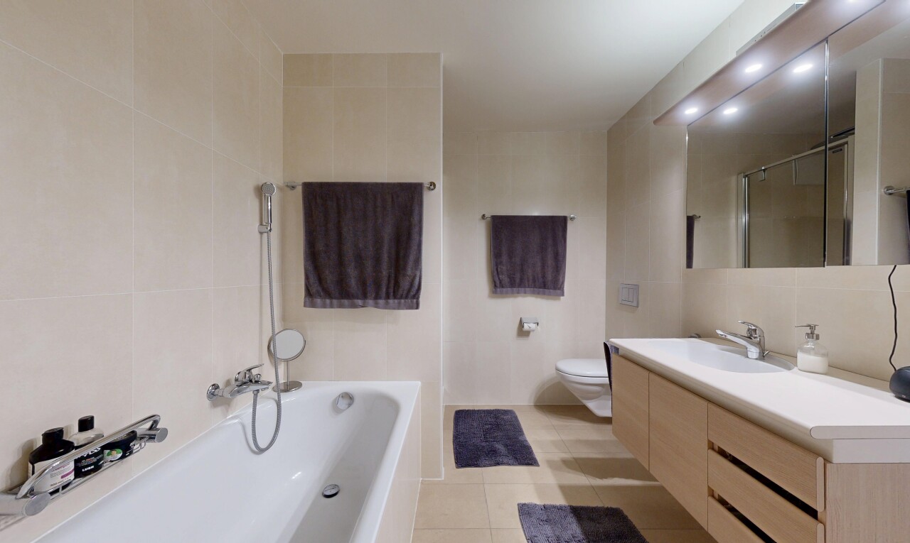 full bath featuring tile walls, vanity, a tub, a shower, and light tile patterned floors