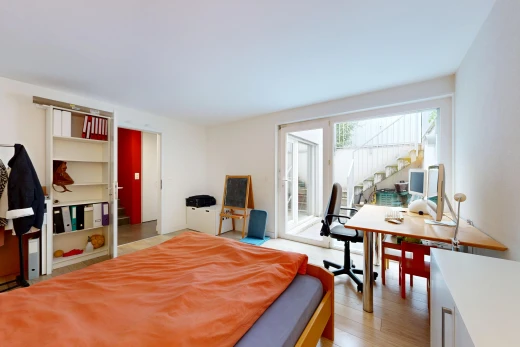 chambre avec accès à l'extérieur, escaliers, cloison sèche, drywall, et wood finish floor