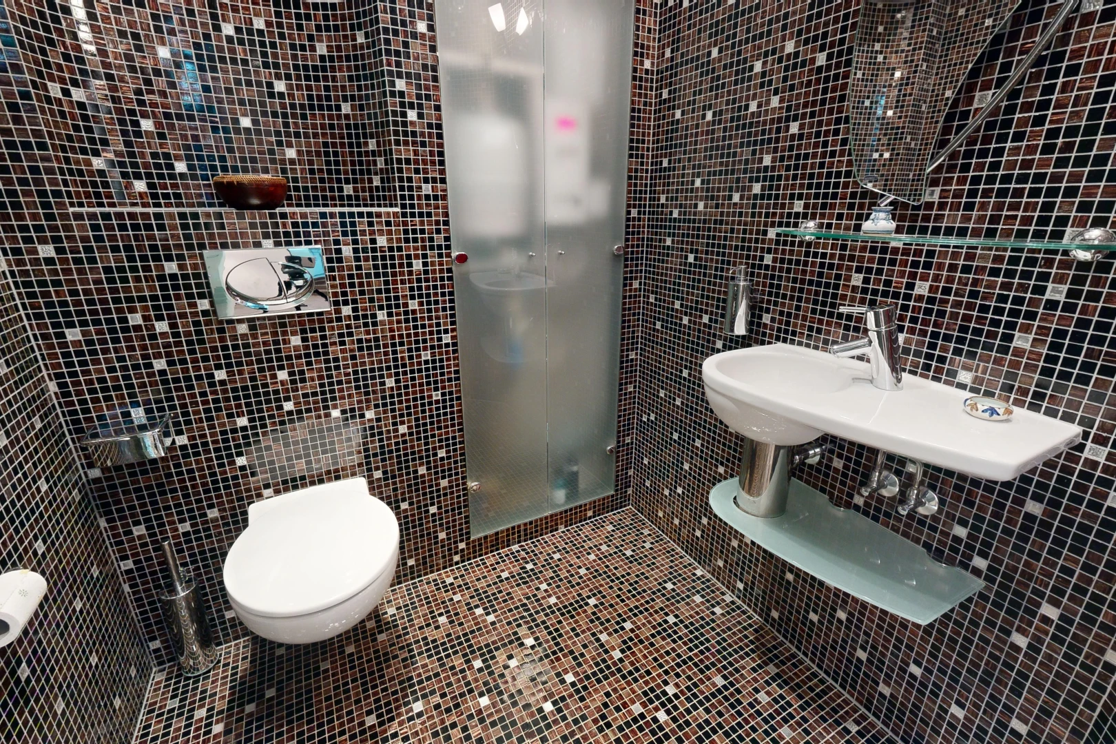 salle de bains avec mur carrelé, toilettes, et carrelage