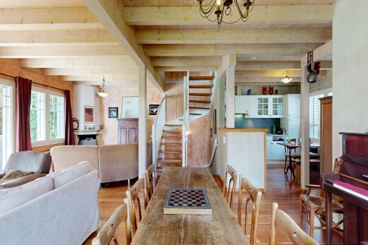 living / dining area with wood finished floors, suspended lighting, and beam ceiling