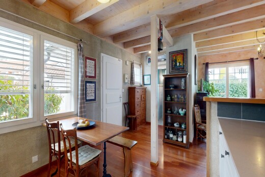 dining space featuring dark wood finished floors and beam ceiling