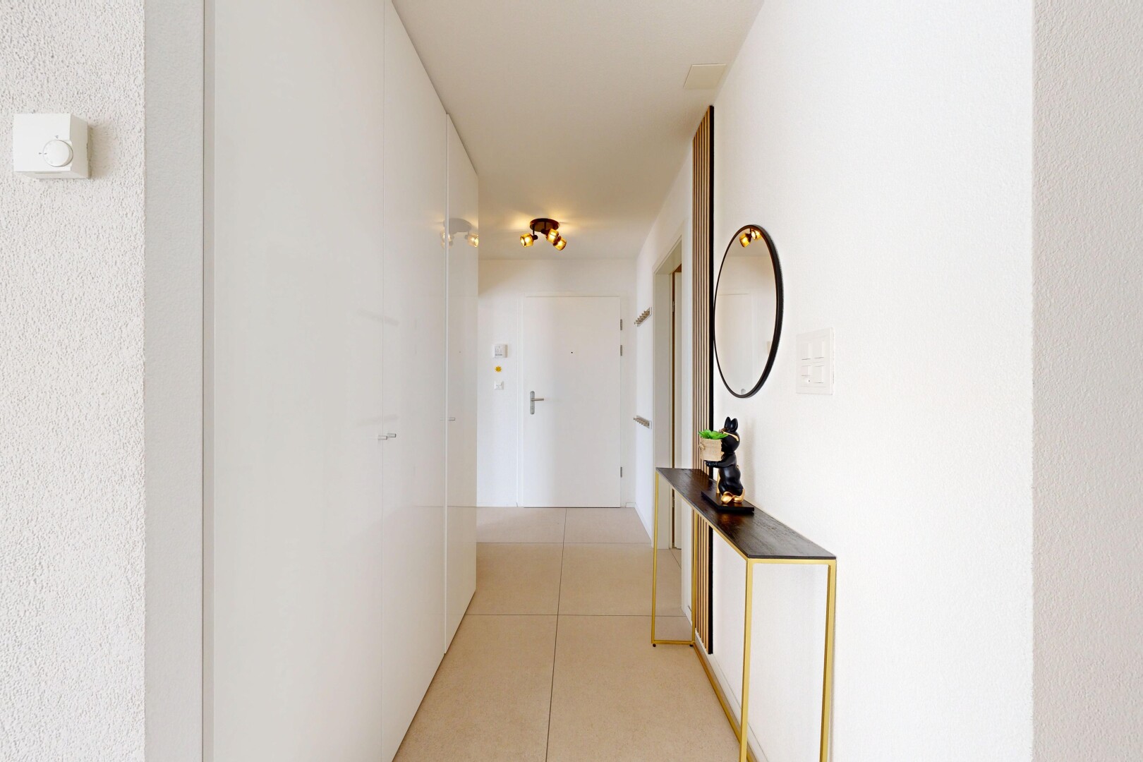hall featuring light tile patterned floors
