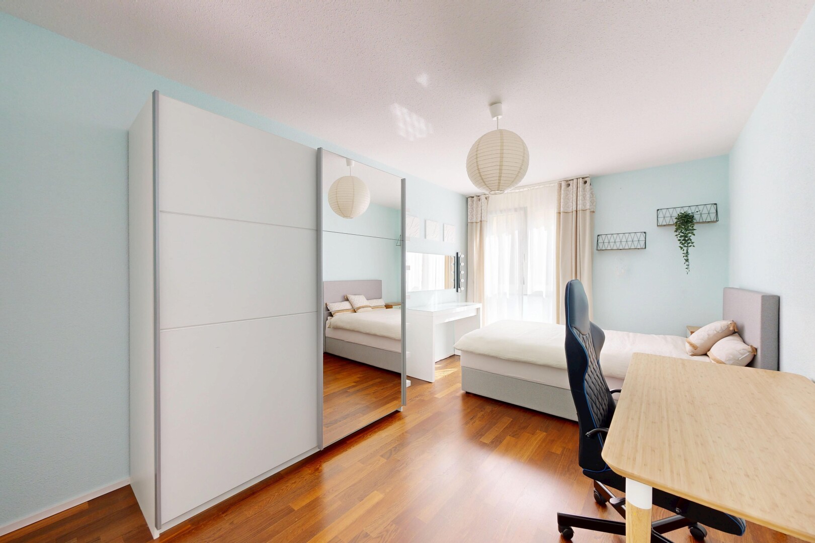 room / bedroom with a desk and wood finished floors
