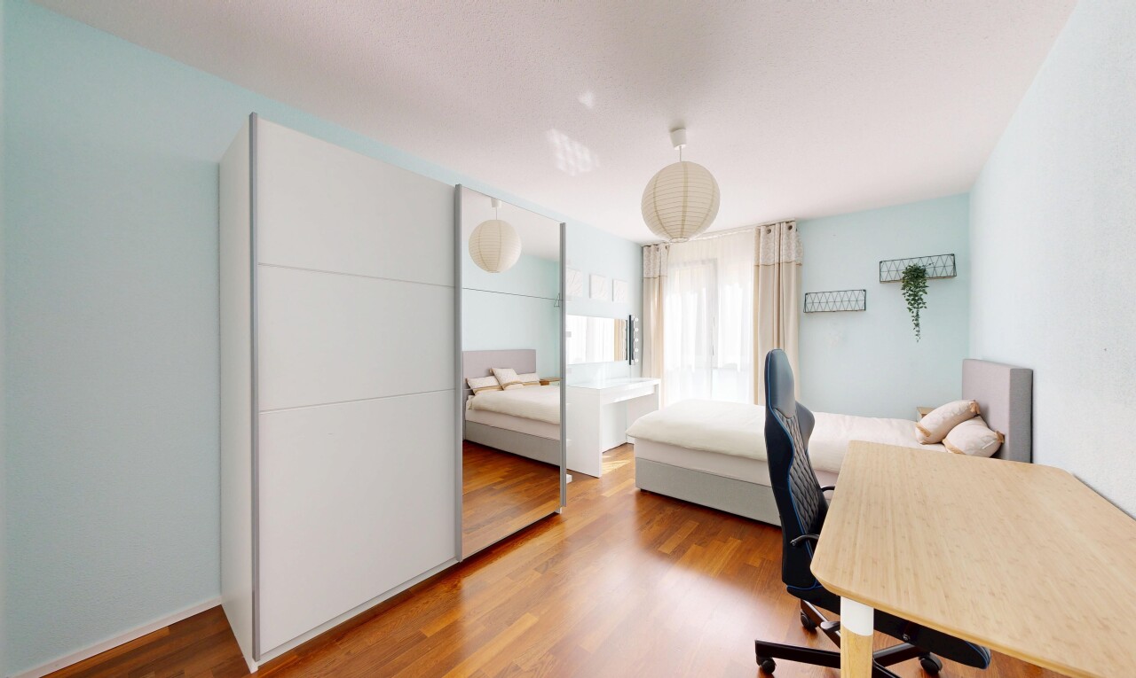 room / bedroom with a desk and wood finished floors