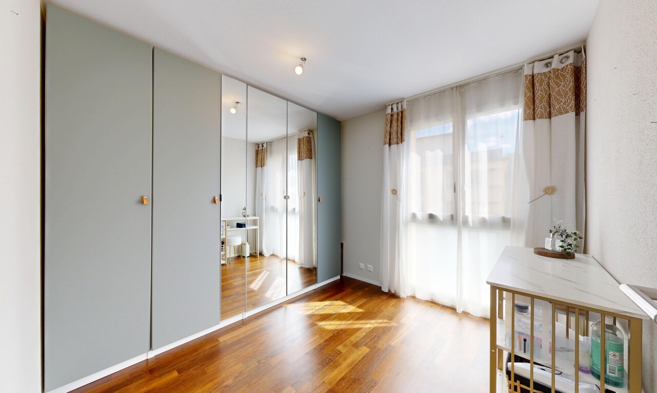 room / bedroom with wood finished floors and multiple windows