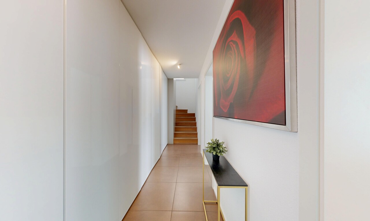 hallway with stairway and light tile patterned flooring