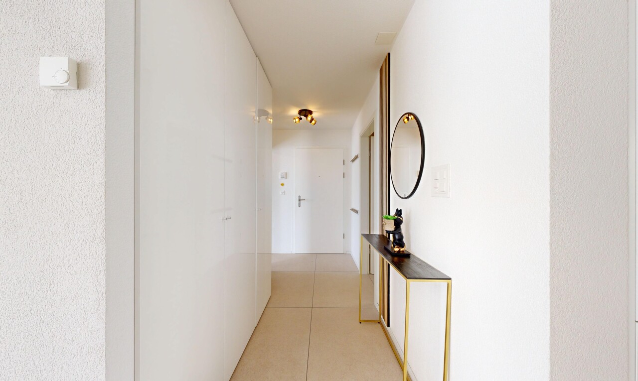 hall featuring light tile patterned floors