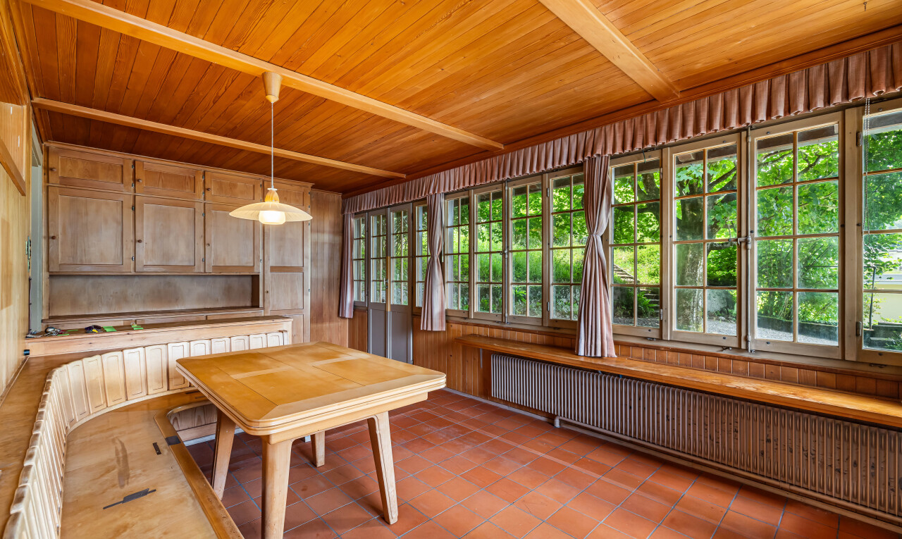 patio / terrace featuring radiator heating unit and a sunroom
