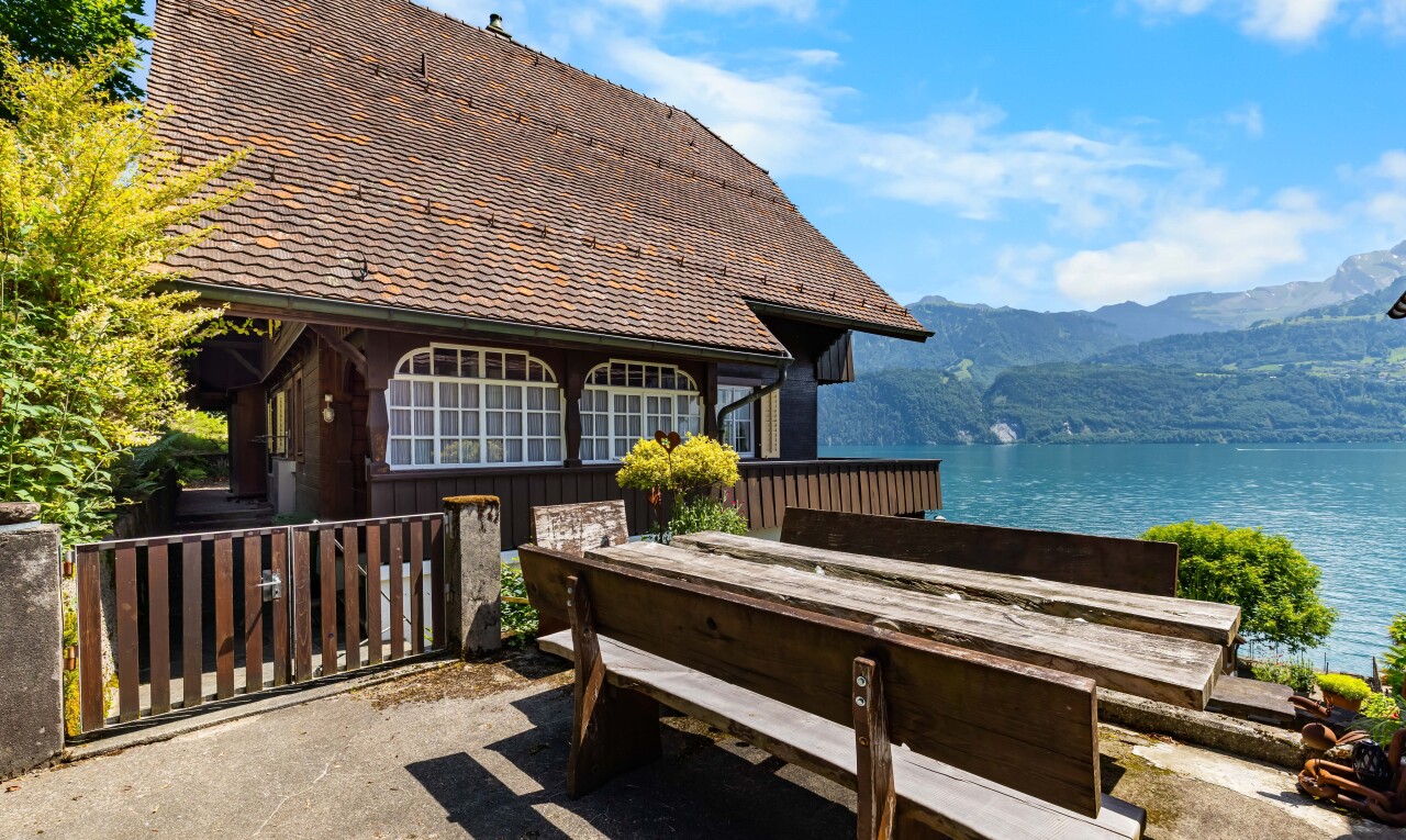 view of home featuring a water and mountain view and a patio area