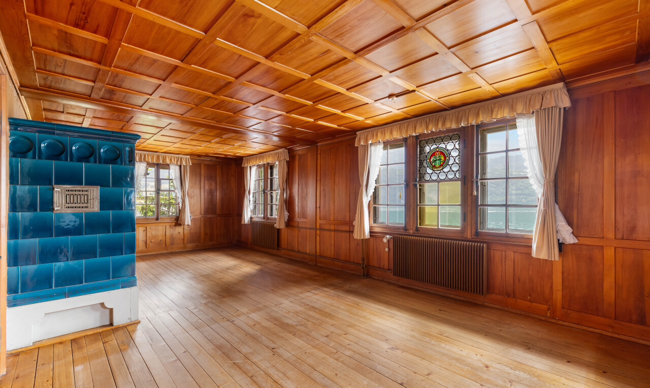 spare room with wooden ceiling, light wood finished floors, wood walls, and radiator heating unit