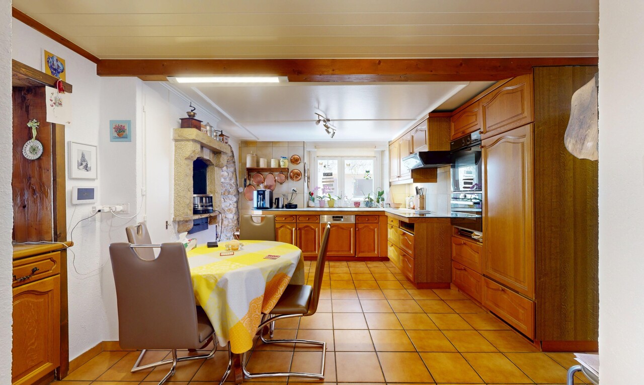 cuisine avec armoires en arc, armoires marron moyen, inside property, tile floor, et sol en carrelage