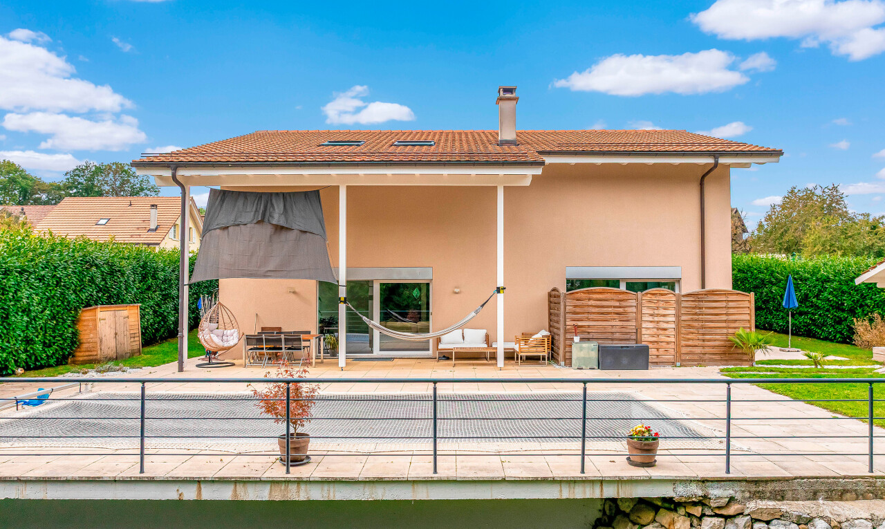 view of property with a patio area, a chimney, and stucco siding