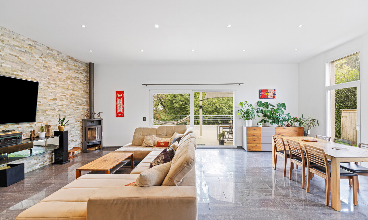 living / dining room featuring recessed lighting and a wood stove