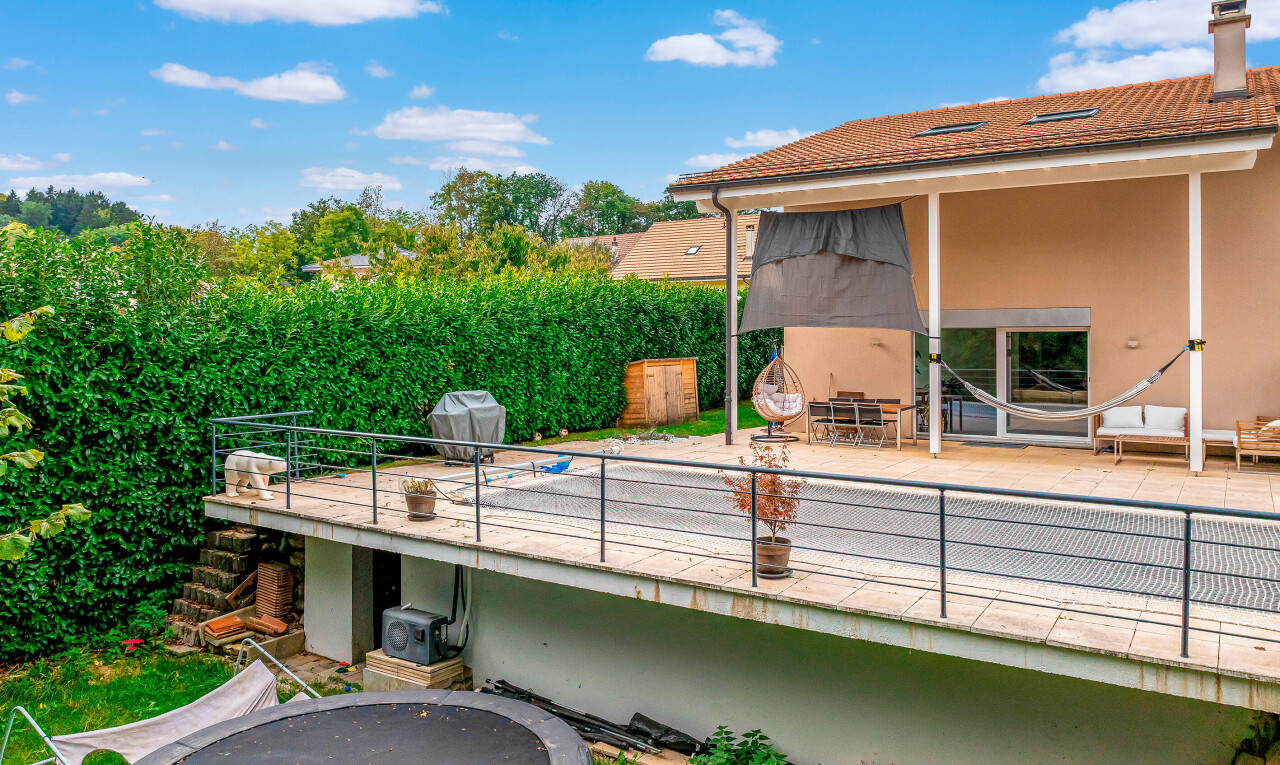 view of property with a patio, stucco siding, and a chimney