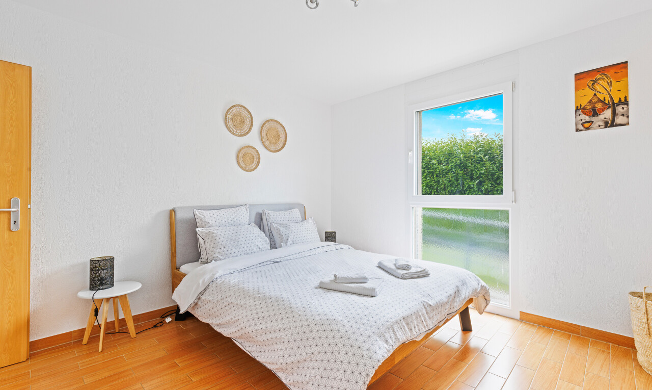 room / bedroom with baseboards and light wood finished floors