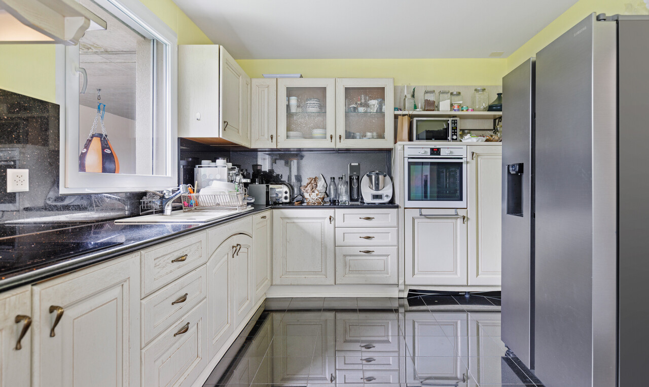 kitchen featuring appliances with stainless steel finishes, glass insert cabinets, white cabinetry, and open shelves