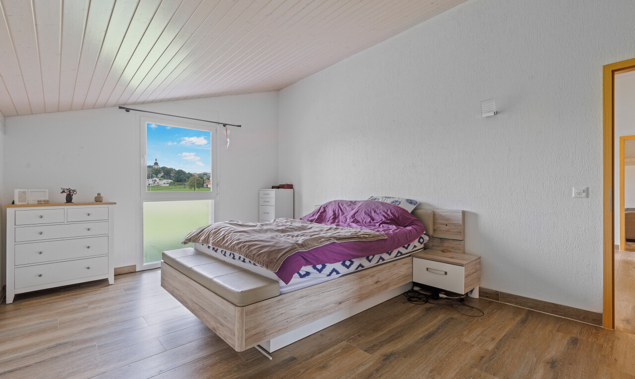 room / bedroom with vaulted ceiling and wood finished floors