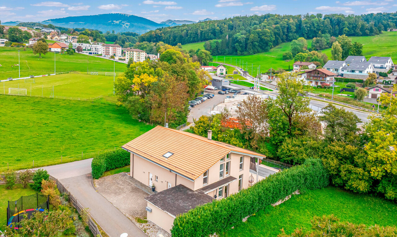 view of home featuring a mountain view and a lawn