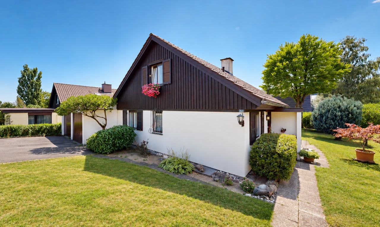 außenansicht mit property visible, auffahrt, stuckverkleidung, rasen, und garage angeschlossen