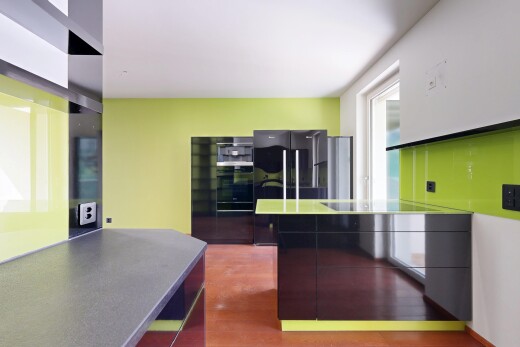 kitchen featuring modern cabinets, light wood-style flooring, oven, and freestanding refrigerator