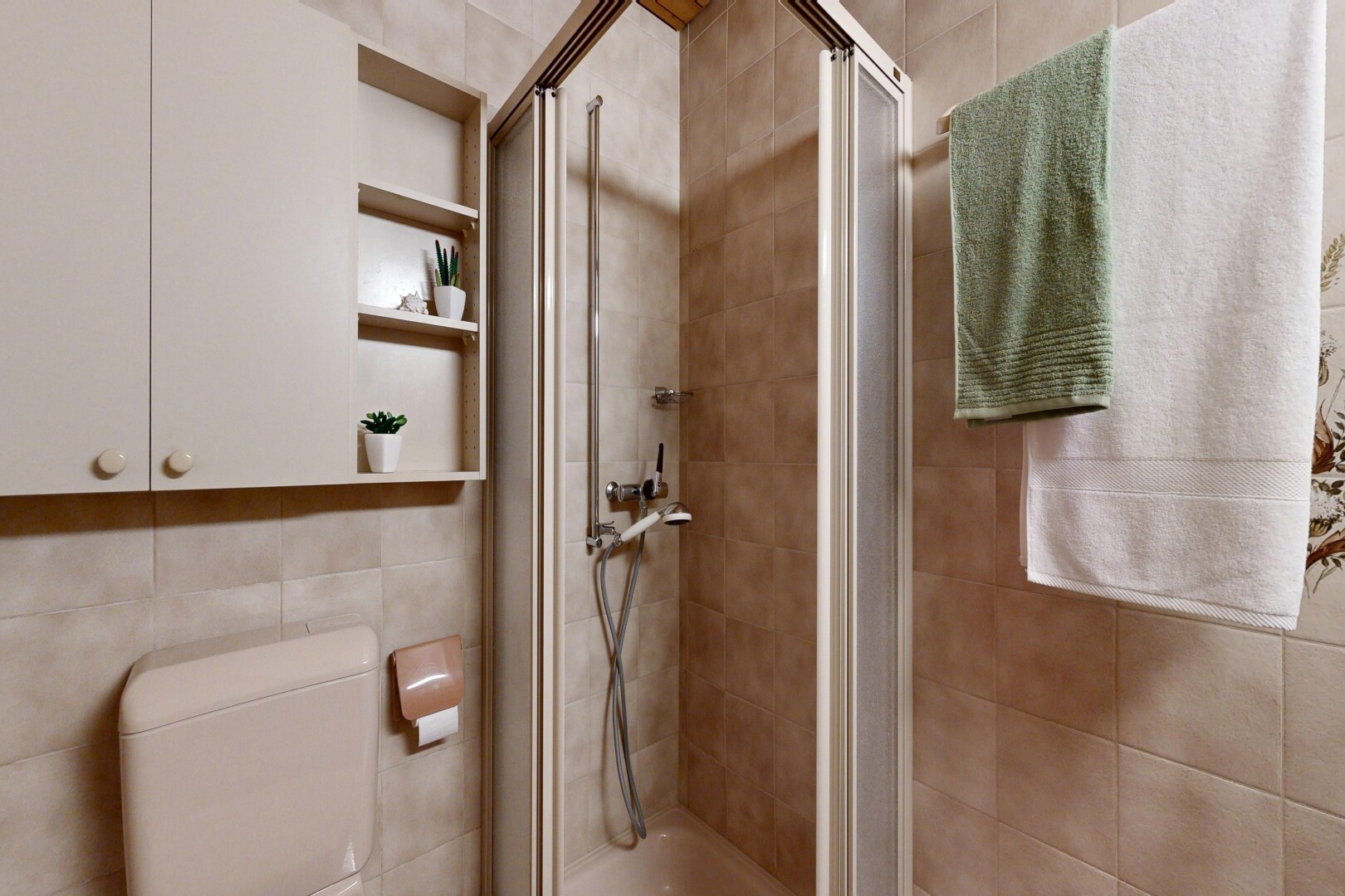 bathroom featuring a stall shower and tile walls