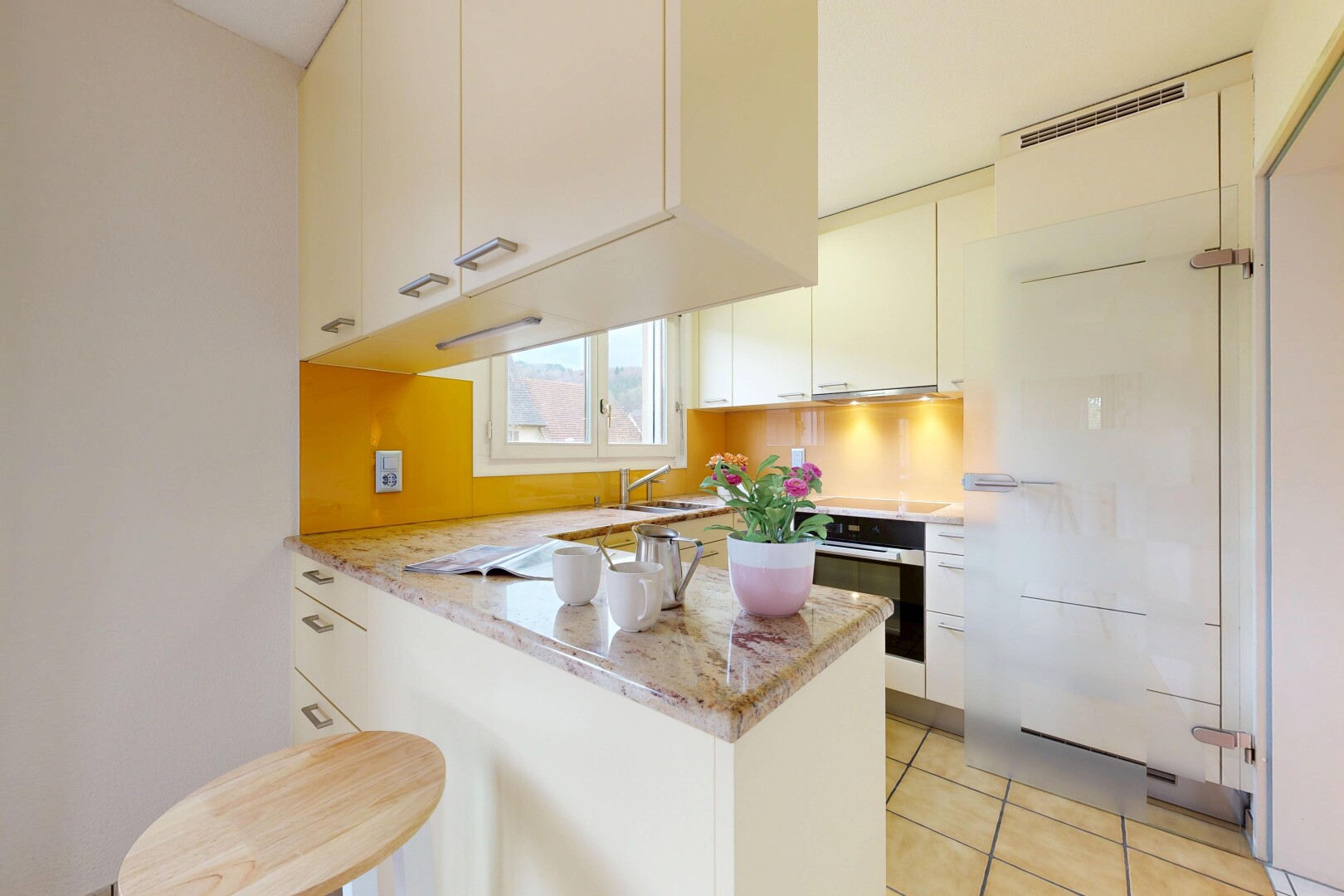 kitchen featuring a peninsula, oven, light stone countertops, and white cabinetry