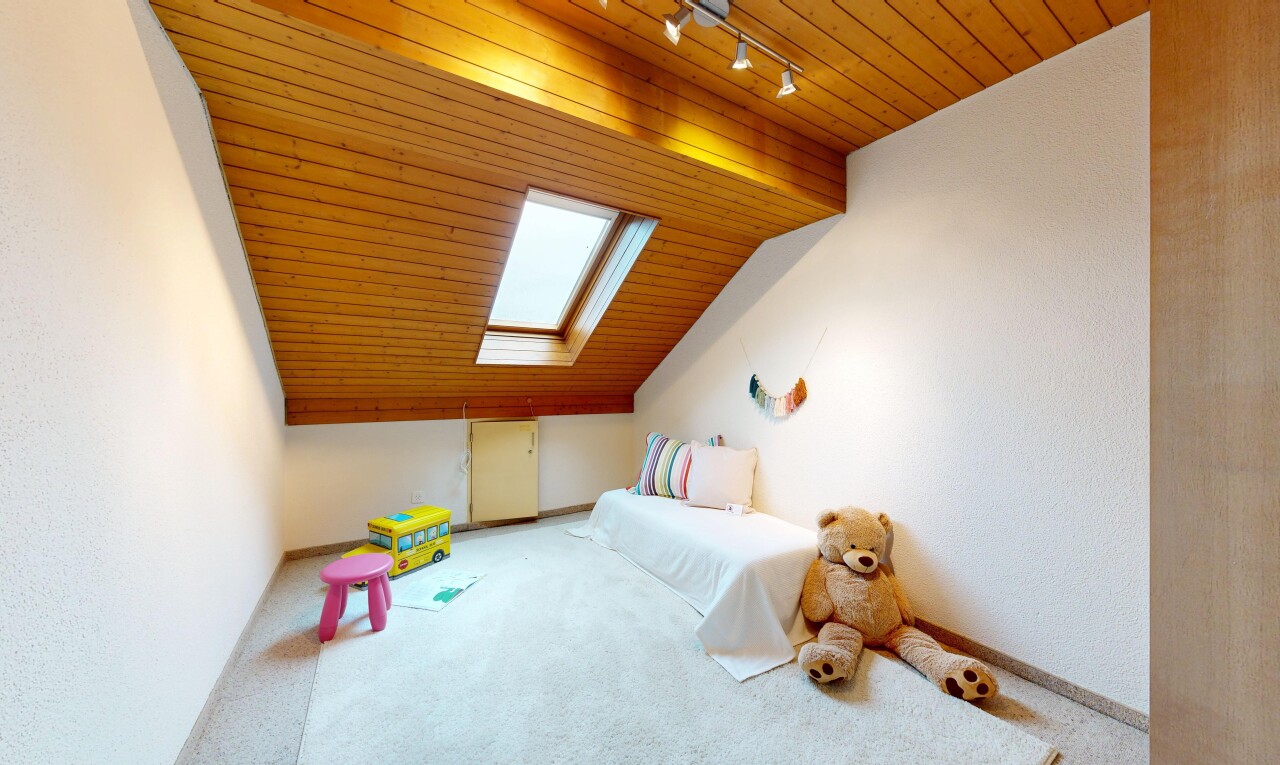 room with a vaulted wooden ceiling, carpet floors, track lighting, and a skylight