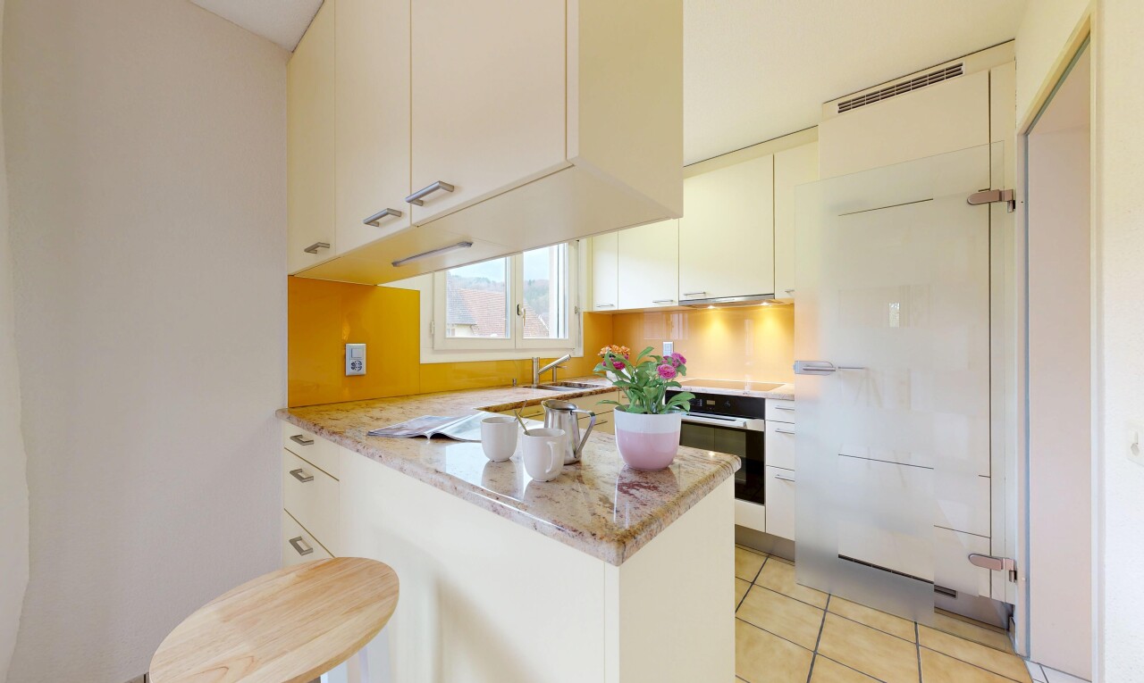 kitchen featuring a peninsula, oven, light stone countertops, and white cabinetry