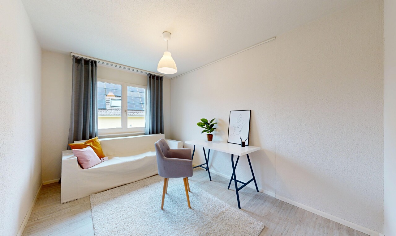 living area with baseboards and light wood-type flooring