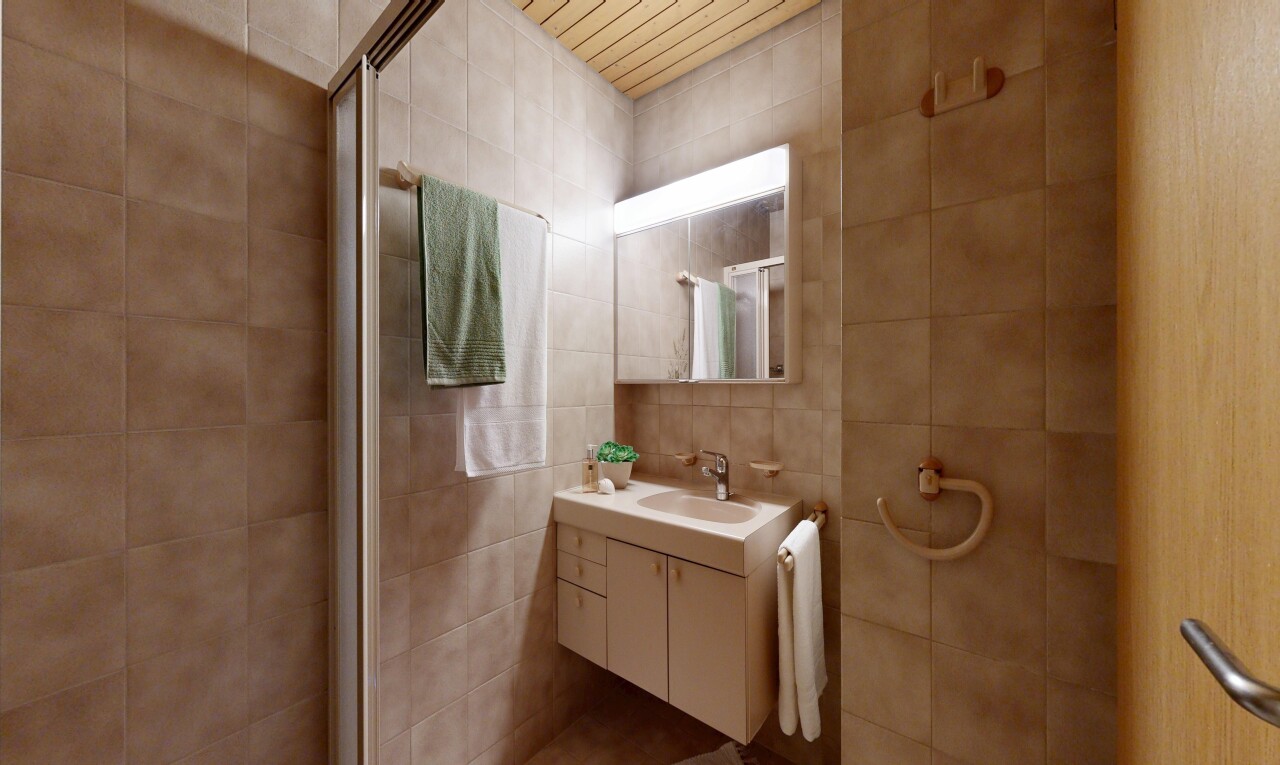 full bathroom featuring vanity and tile walls