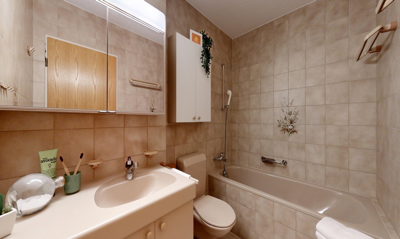 full bathroom with tile walls, vanity, tiled shower / bath, and backsplash
