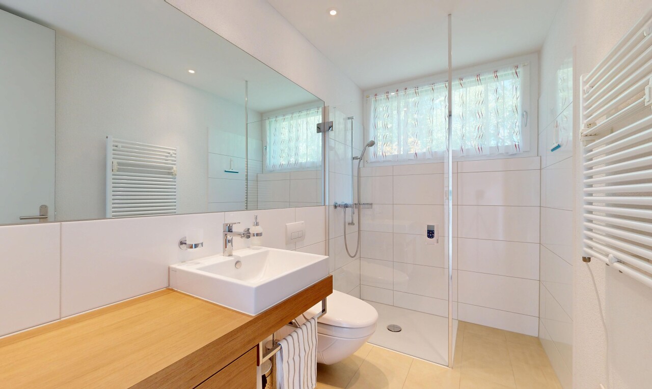 full bath featuring a towel warming rack, radiator heating unit, vanity, a stall shower, and recessed lighting