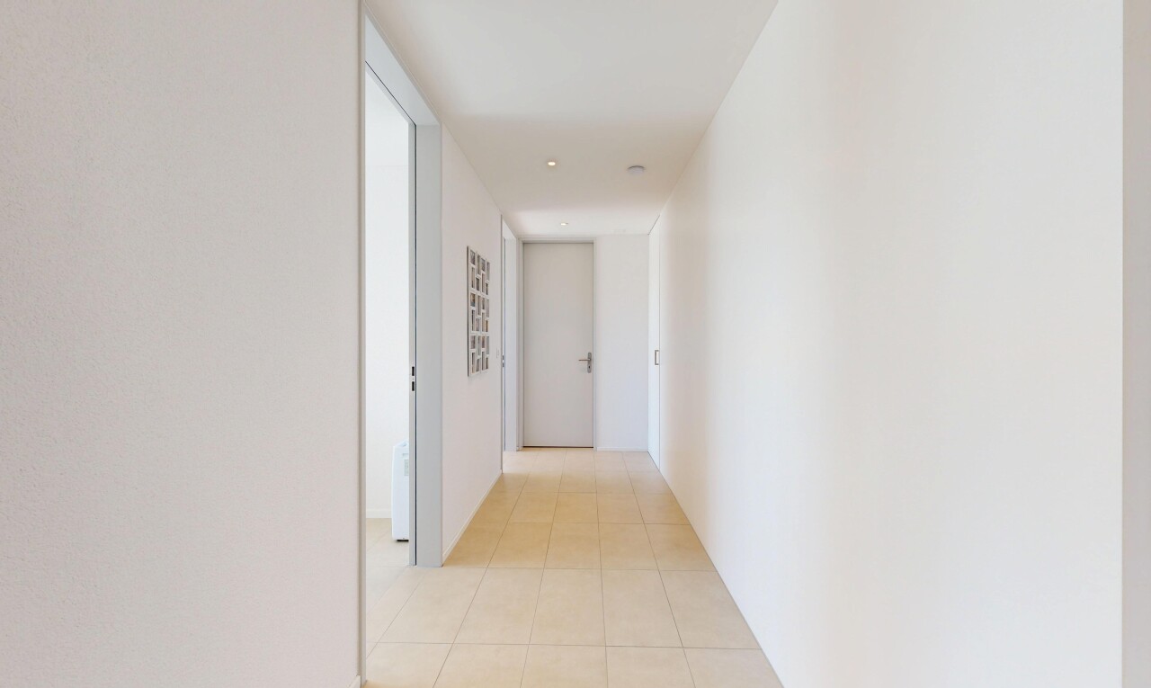 hall with light tile patterned floors