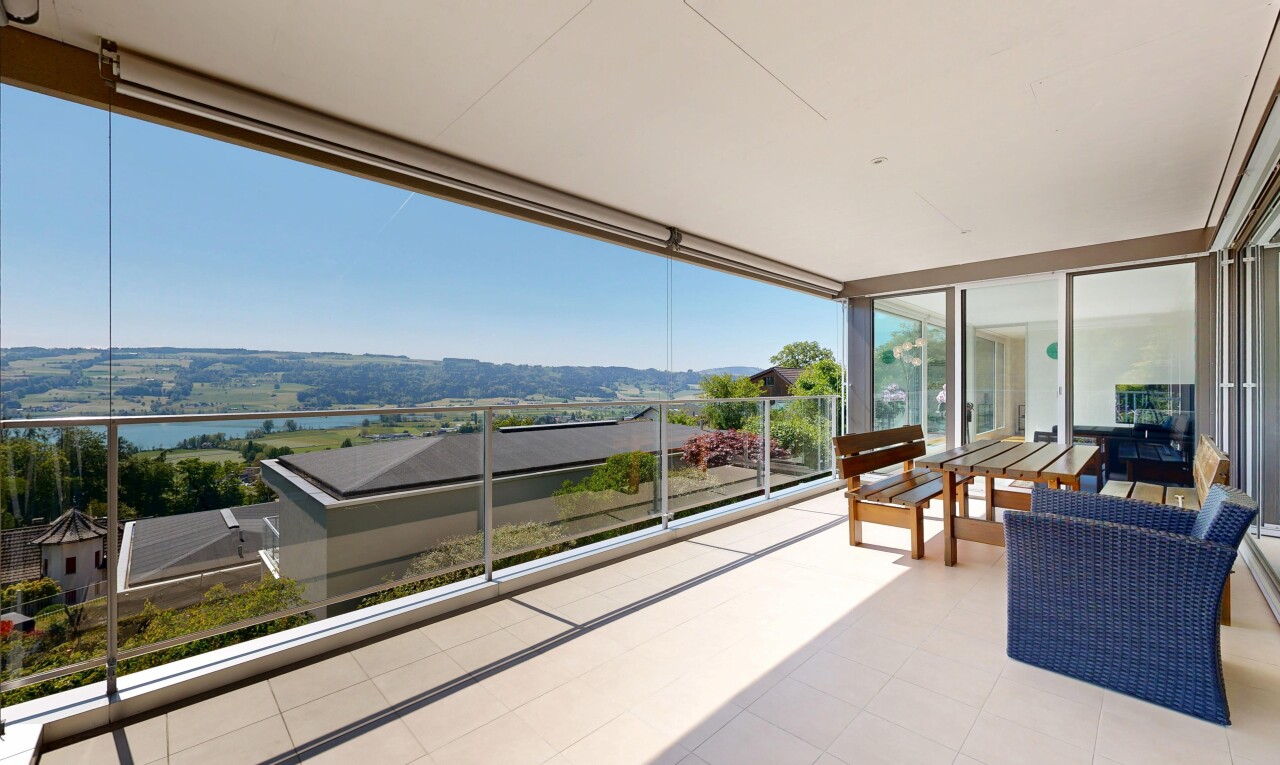 terrace with a patio area and a water view