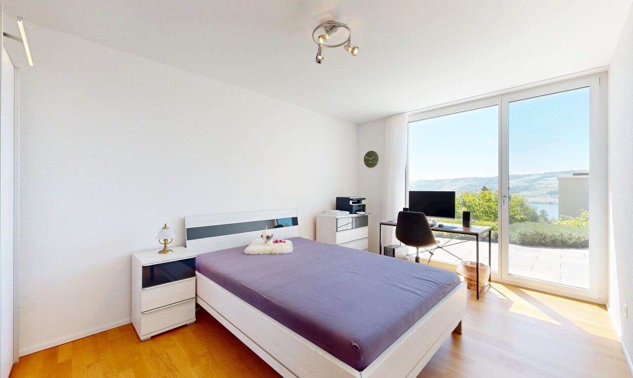 room / bedroom featuring light wood finished floors, an office area, access to outside, and expansive windows