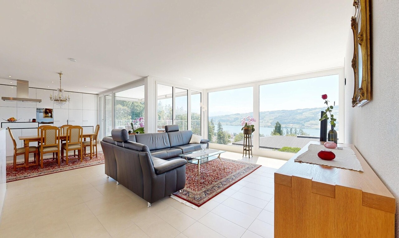 living / dining area with floor to ceiling windows and hanging lights