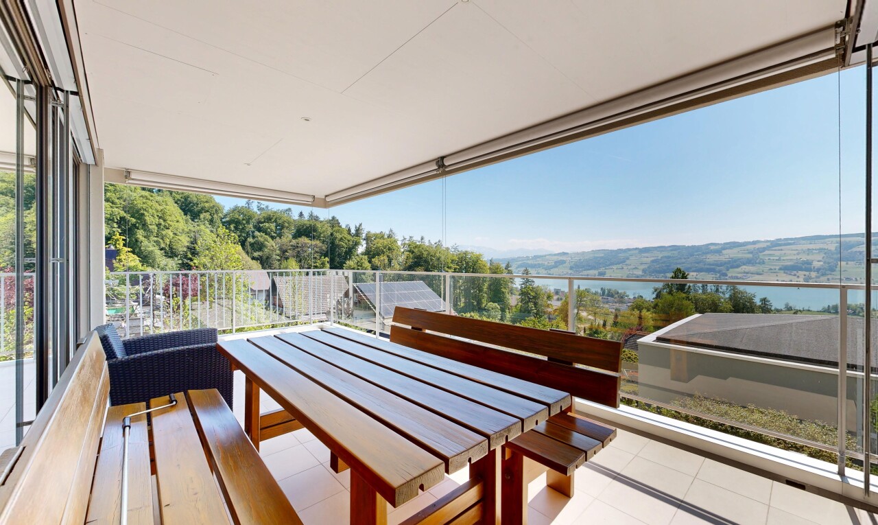 terrace featuring a patio area, outdoor dining area, and a water view