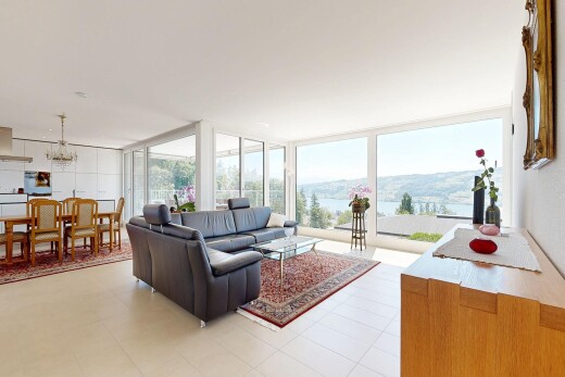 living / dining area with floor to ceiling windows and hanging lights