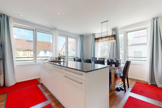 cuisine avec day time, sol en finition bois, wood finish floor, dark countertops, et plinthes murales