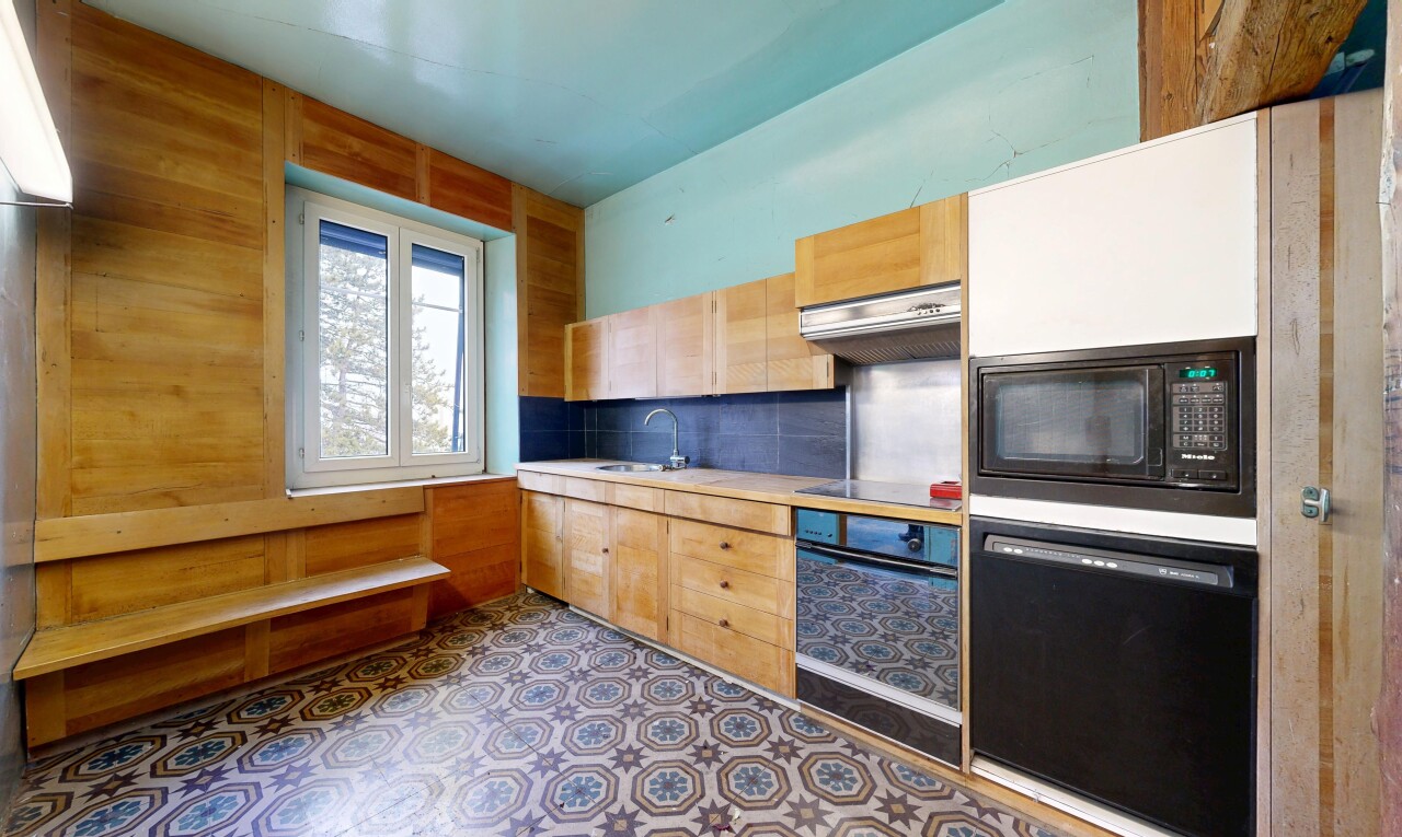 cuisine avec armoires marron clair, light brown cabinets, plans de travail, light countertops, et four