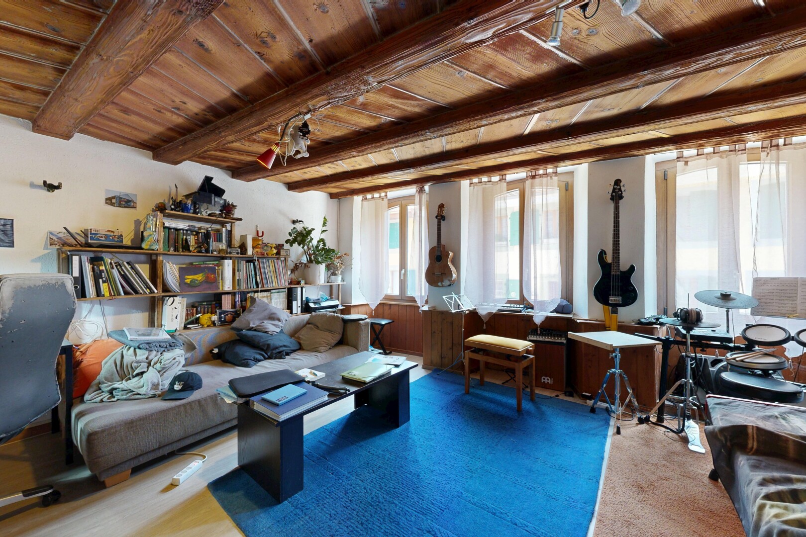 living area featuring a wood ceiling with exposed beams