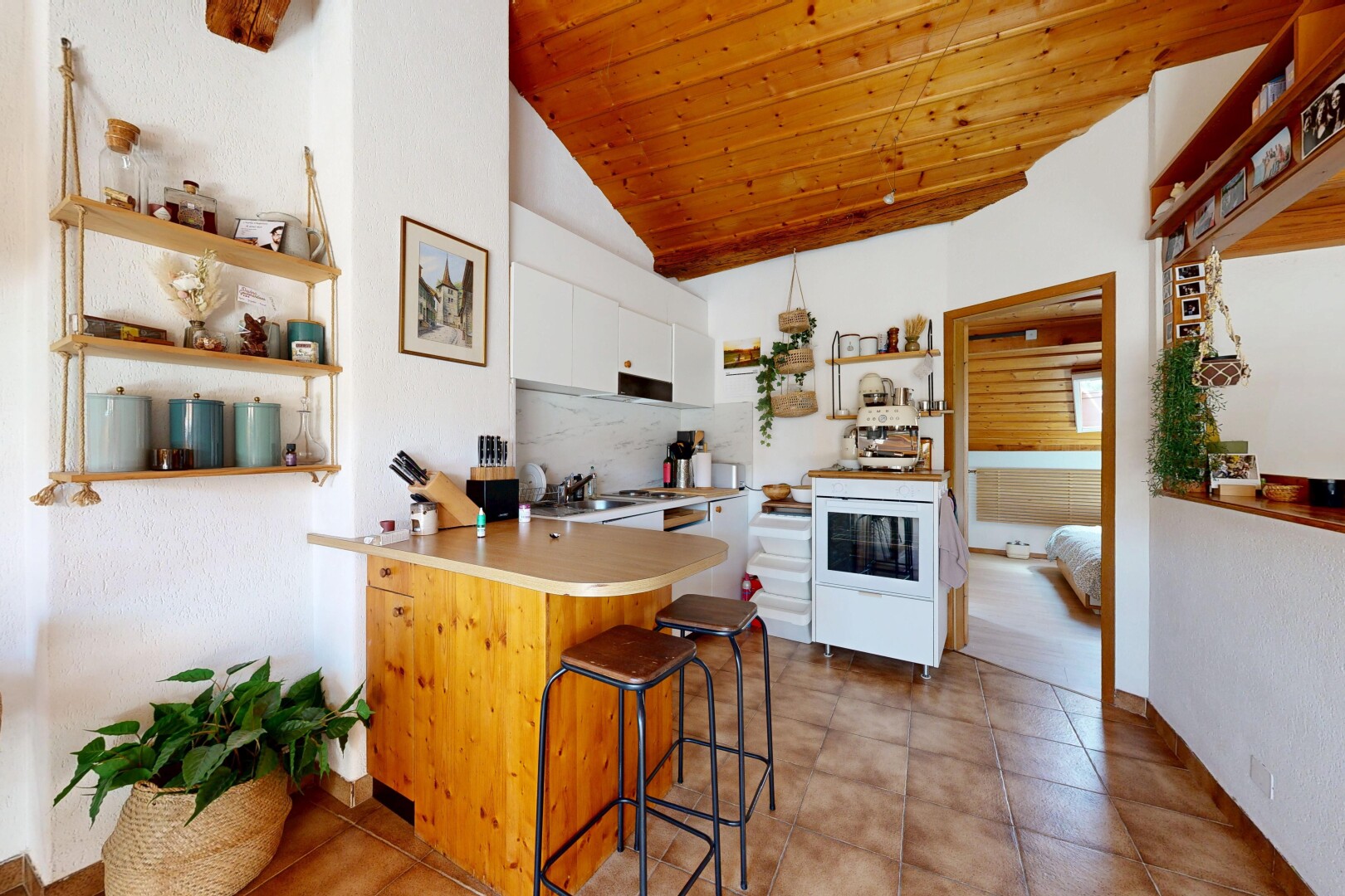 kitchen featuring a vaulted wood ceiling, light countertops, a breakfast bar area, open shelves, and a peninsula