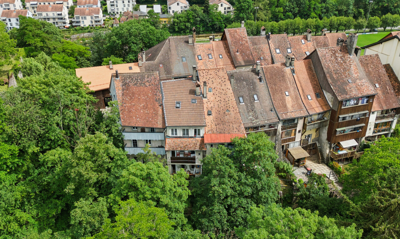 view of property featuring view of wooded area