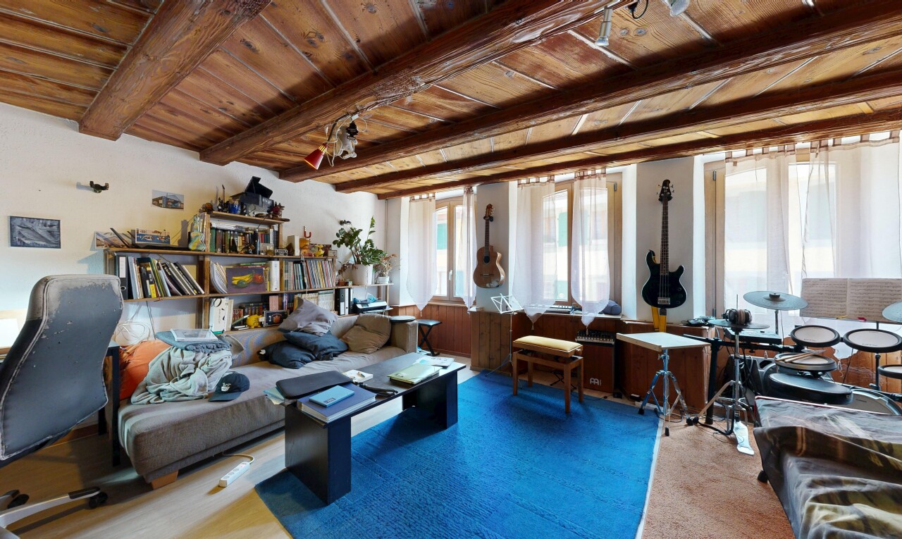 living area featuring a wood ceiling with exposed beams