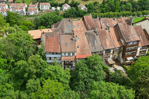 view of property featuring view of wooded area