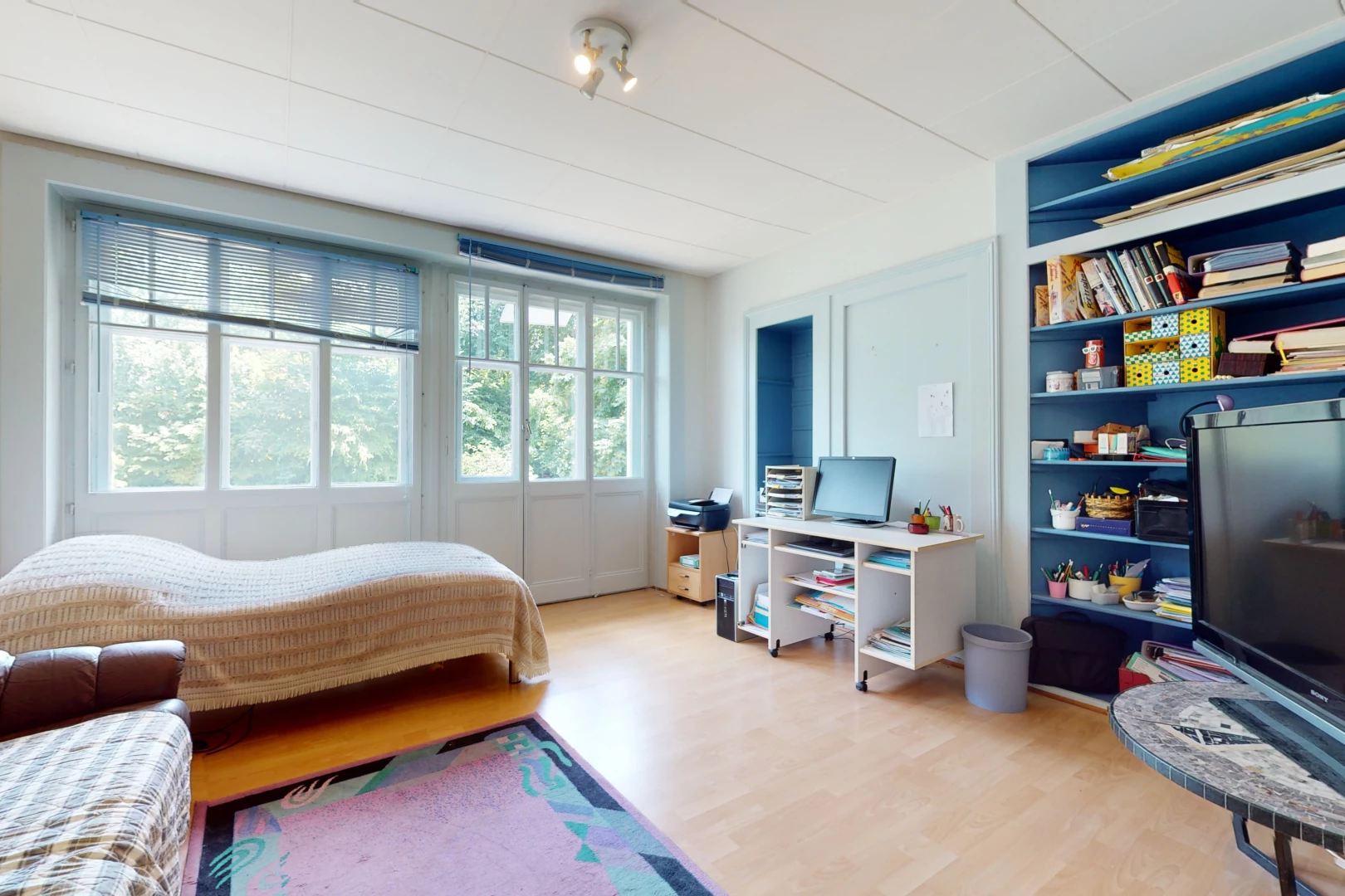 bedroom with hardwood floors, natural light, and TV