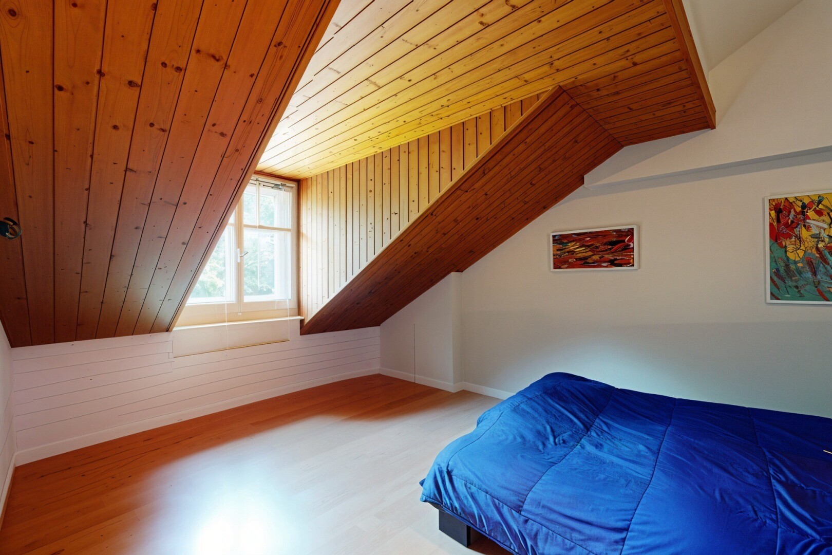 room with a vaulted wooden ceiling, wood finished floors, and wooden walls